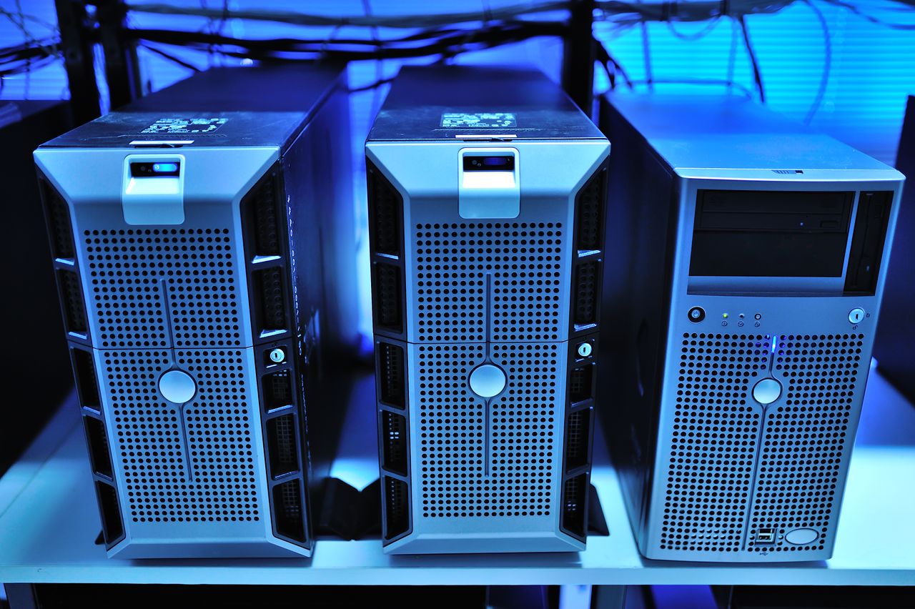 hero-img-02 Close-up view of modern rack-mounted server units in a data center.